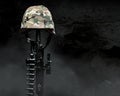 Fallen soldier camouflaged helmet on rifle Royalty Free Stock Photo