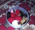 This is the photo of candy in bowl looking tasty in different shapes..