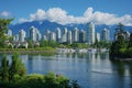 This photo captures a cityscape featuring a city surrounded by majestic mountains in the distance, Vancouver\'s cityscape