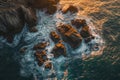 This photo captures an expansive aerial view of the ocean and rocks, showcasing the natural beauty and ruggedness of the landscape