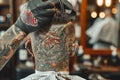 This photo captures a man in a barber shop, receiving a haircut in a traditional grooming setting, A hairdresser with tattoos