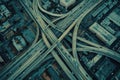 This photo captures a sprawling highway intersection from above, showcasing the urban landscape beneath, A maze of city roads and