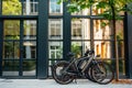 A photo capturing a pair of bicycles parked side by side in front of a building, Electric bicycles parked outside an office