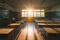 A photo capturing the quietness and simplicity of an empty classroom with wooden desks aligned neatly and green chalkboard walls, Royalty Free Stock Photo