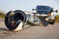 Photo of car, helmet and motorcycle on the road, the concept of road accidents Royalty Free Stock Photo