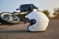 Photo of car, helmet and motorcycle on the road, the concept of road accidents Royalty Free Stock Photo