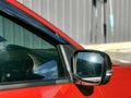 Photo of car rear view mirror with signal lamp and window. Royalty Free Stock Photo