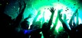 Photo of carefree bachelors fellows enjoy rejoice sound show disco floor raise hands up under colorful futuristic lights