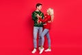 Photo of carefree couple in love dance wear ugly pullover jeans footwear isolated red color background Royalty Free Stock Photo