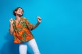 Photo of carefree girl wear stylish nice outfit dancing looking empty space seasonal special cool offer isolated on blue