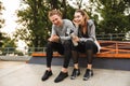 Photo of caucasian athletic couple guy and girl 20s in tracksuit