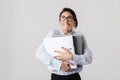 Photo of caucasian female worker wearing eyeglasses holding paper folders in the office, isolated over white background Royalty Free Stock Photo