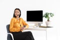 Photo of caucasian phone operator woman wearing microphone headset holding smartphone while working in office