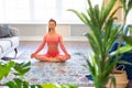 Photo of a caucasian woman meditatin at home.