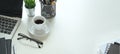 Photo of ceramic coffee cup with small dish putting on white working desk. Royalty Free Stock Photo