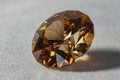 Photo of a Champagne colored Cubic Zirconia gemstone, cut in the shape of a Standard Round Brilliant design PvNiel on a white ve