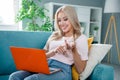 Photo of charming adorable cheerful girl sitting comfort apartment sofa counting numbers fingers discussing news weekend Royalty Free Stock Photo