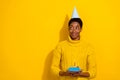 Photo of charming adorable girl look empty space make wish wear birthday cone hat eating delicious cake isolated on Royalty Free Stock Photo