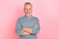 Photo of charming attractive retired man wear grey shirt arms folded isolated pink color background Royalty Free Stock Photo