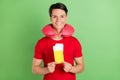 Photo of charming attractive young man wear red t-shirt neck pillow holding tickets isolated green color background