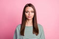 Photo of charming calm cute young lady look camera shy smile wear striped shirt pink color background