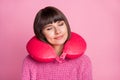 Photo of charming calm sleepy woman good mood wear neck pillow smile isolated on pink color background