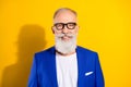 Photo of charming cheerful attractive old man wear glasses smile good mood isolated on yellow color background