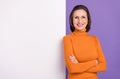 Photo of charming confident lady dressed orange turtleneck glasses arms crossed empty space billboard isolated purple Royalty Free Stock Photo