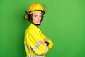 Photo of charming confident young fire lady workwear yellow helmet arms folded empty space isolated green color