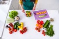 Photo of charming cute dark skin woman dressed yellow shirt cooking stir salad indoors house home room Royalty Free Stock Photo