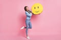 Photo of charming cute lady hold big emoticon wear blue pullover jeans footwear isolated pink background Royalty Free Stock Photo