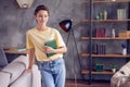 Photo of charming cute lady hold textbook think look aside wear yellow t-shirt in modern apartment indoors