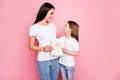 Photo of charming cute mommy little daughter ladies hold 8 march postcard feelings hugging look eyes wear casual t