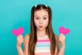 Photo of charming cute playful girl wear stylish striped clothes two hands hold pink heart shape send kiss isolated blue Royalty Free Stock Photo