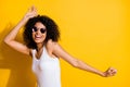 Photo of charming dark skin woman happy dance wear cool sunglass copyspace on vibrant yellow color background