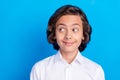 Photo of charming dreamy school boy wear formal outfit smiling looking empty space blue color background