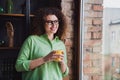 Photo of charming dreamy woman drinking tasty morning coffee looking window modern office loft room interior indoors Royalty Free Stock Photo