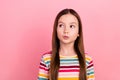 Photo of charming face small girl kid pouty lips comic humorous looking empty space thoughtful dreamy isolated on pink Royalty Free Stock Photo