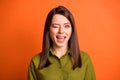 Photo of charming flirty girl look camera blink close eye wear green shirt isolated orange color background