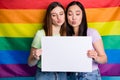 Photo of charming flirty lesbians couple ladies protest parade day tolerance same sex marriage send air kiss gay rainbow
