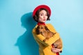 Photo of charming flirty young lady wear yellow blazer red cap smiling holding small friend lips pouted isolated blue