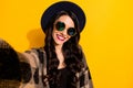 Photo of charming happy woman make camera selfie hipster retro hat isolated on yellow color background