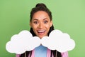 Photo of charming impressed dark skin woman dressed striped shirt holding two mind clouds empty space isolated green Royalty Free Stock Photo