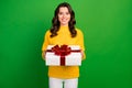 Photo of charming lady hold large paper box with red bow birthday gift for boyfriend wear knitted yellow pullover white