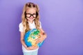 Photo of charming little girl tails eyeglasses embrace globe explore country wear stylish white clothes on