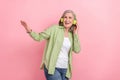Photo of charming lovely retired good mood lady wear green trendy clothes look up empty space nice offer isolated on Royalty Free Stock Photo