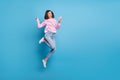 Photo of charming lucky lady dressed pink pullover jumping high typing modern device empty space isolated blue color
