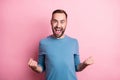 Photo of charming lucky young guy wear blue pullover rising fists open mouth isolated pink color background
