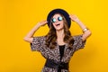 Photo of charming nice dreamy young woman wear hat look empty space rich lady isolated on yellow color background Royalty Free Stock Photo