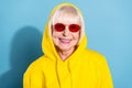 Photo of charming old cheerful woman wear cool sunglass good mood hood isolated on blue color background